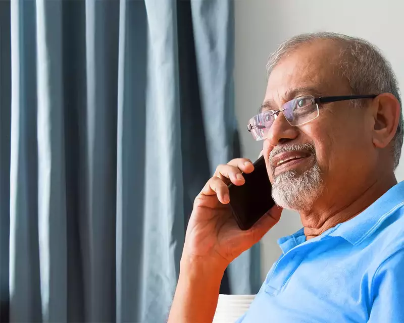male patient on phone to GP surgery using hosted telephony system