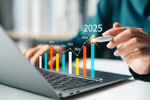 
                      An illustrative bar chart labelled with recent years, representing the idea of budgeting. The chart is superimposed over a laptop and a person is pointing at the current year.
                    