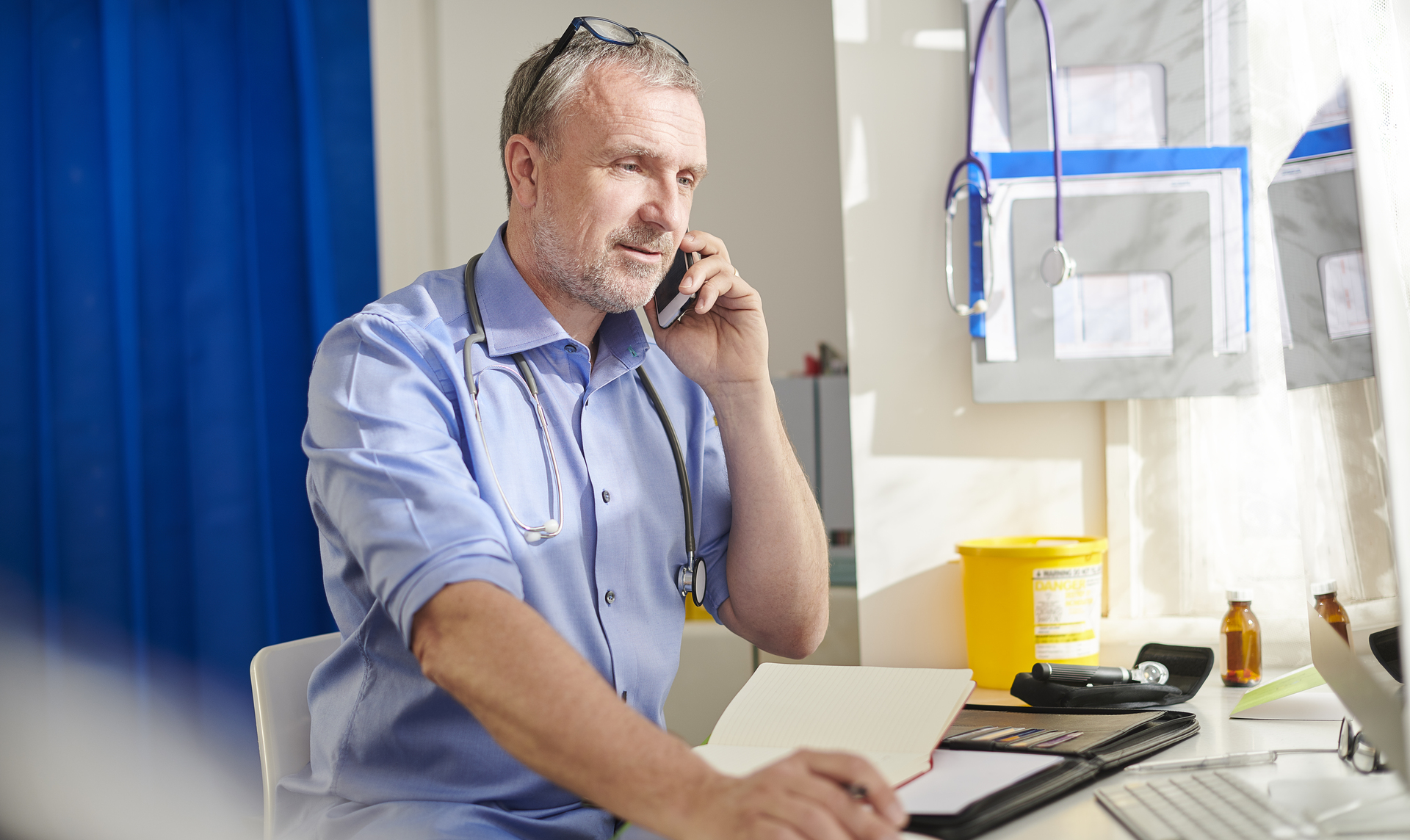 a doctor on the phone at a desk