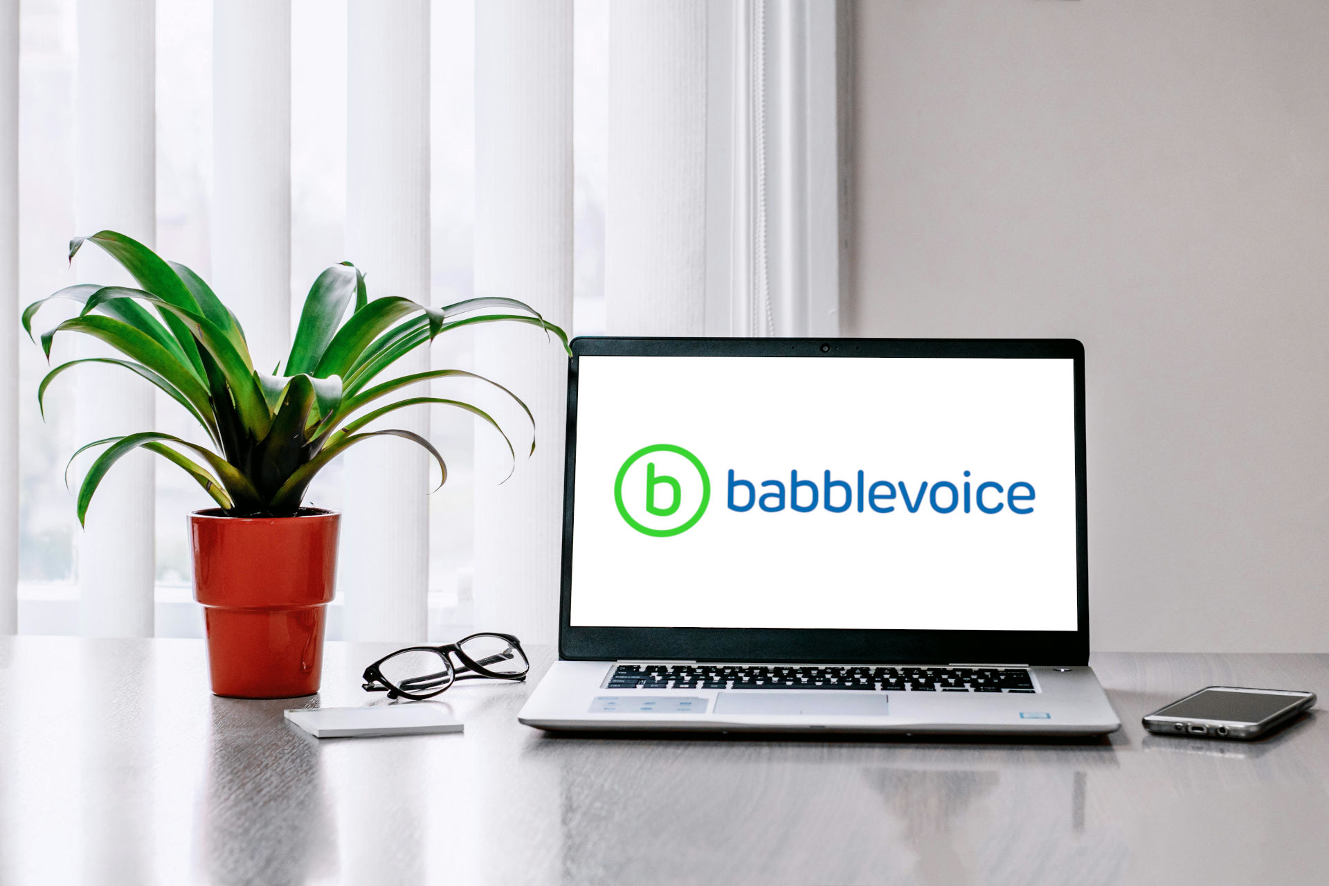 
                a laptop showing the babblevoice logo
              